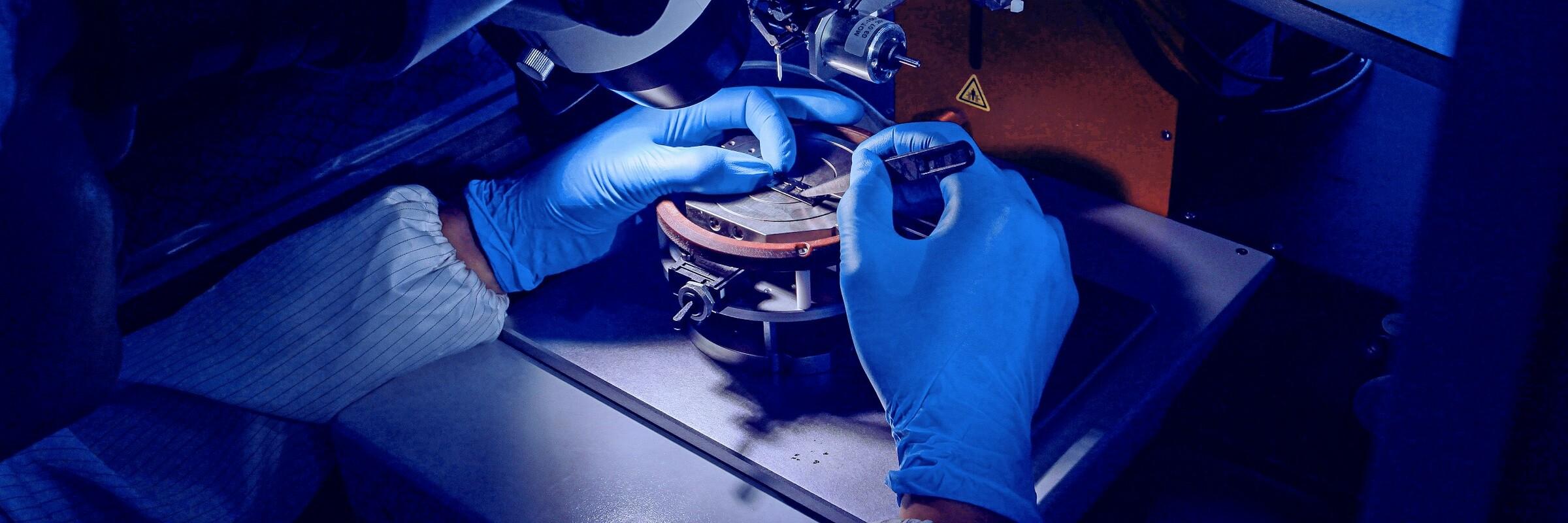 Maschine Precision work performed by hands wearing blue gloves on a machine