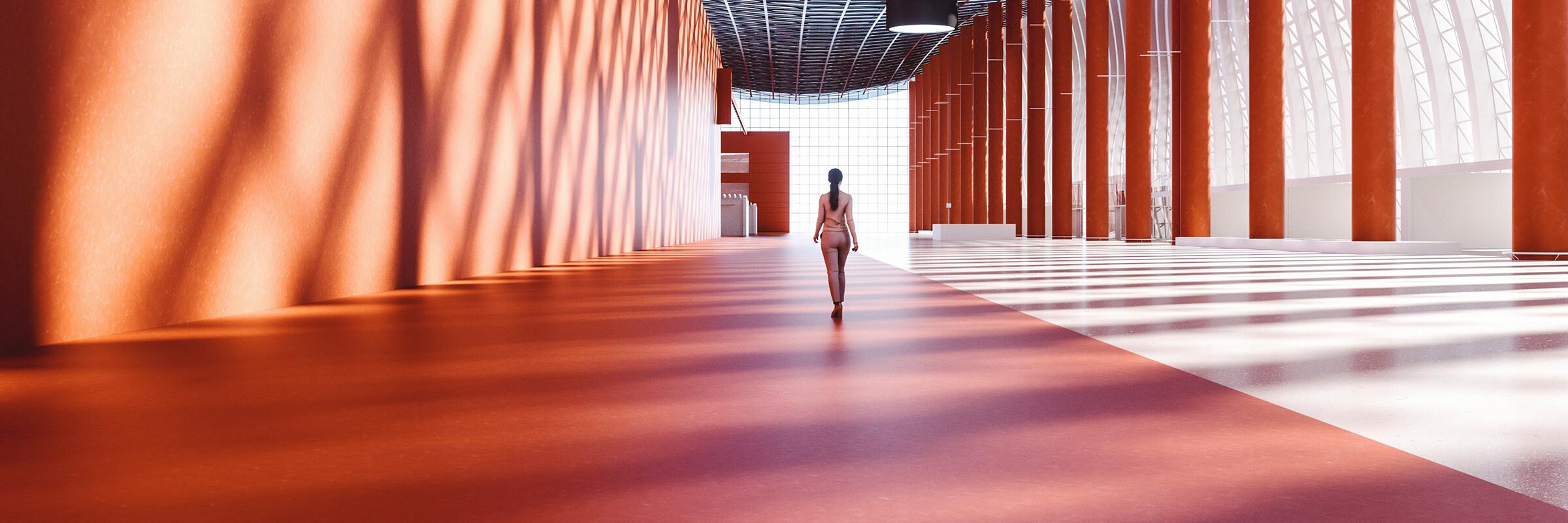 Frau in Gebäude Eine Frau läuft einen hohen Gang hinunter